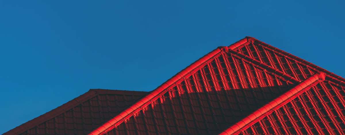Morning sun rising behind a house with a newly installed roof in Buffalo, NY.